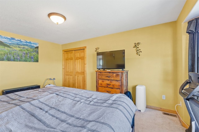 bedroom featuring light carpet and a closet