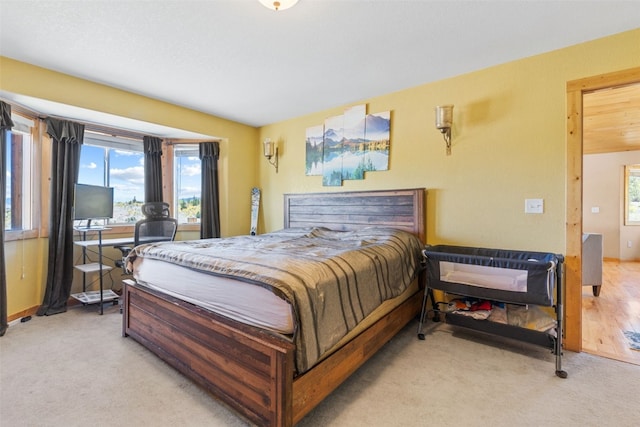 bedroom featuring light carpet