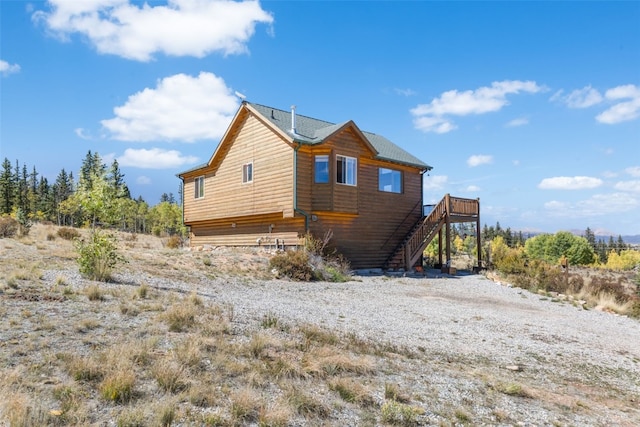 rear view of property featuring a deck