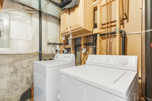 clothes washing area with electric panel and separate washer and dryer