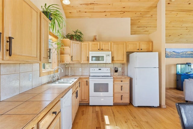 kitchen with light brown cabinetry, white appliances, tile counters, and wooden ceiling