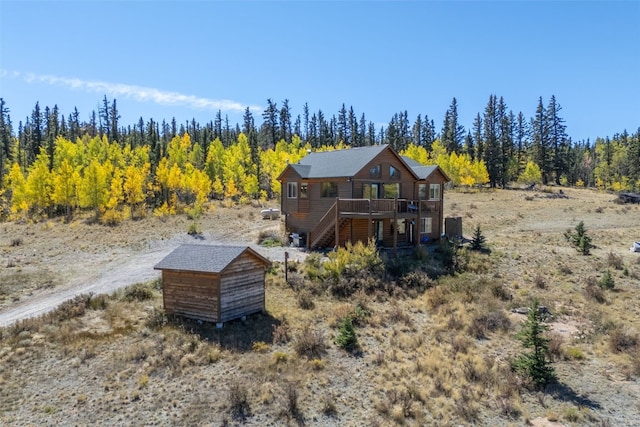 rear view of property with a wooden deck