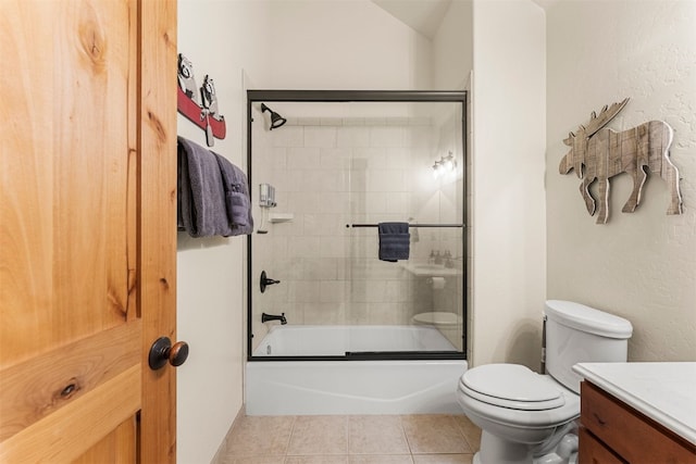 full bathroom with shower / bath combination with glass door, vanity, toilet, and tile patterned floors