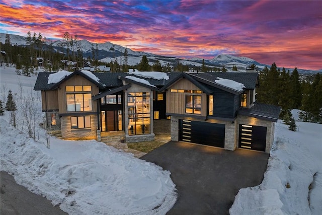 view of front facade with a garage and a mountain view