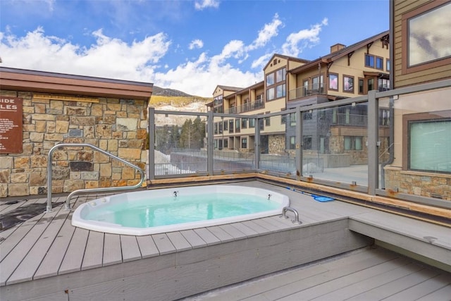 view of swimming pool featuring a hot tub