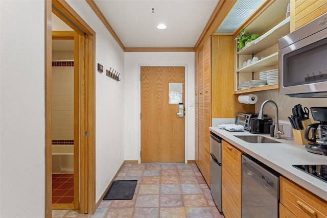 kitchen featuring ornamental molding, appliances with stainless steel finishes, and sink