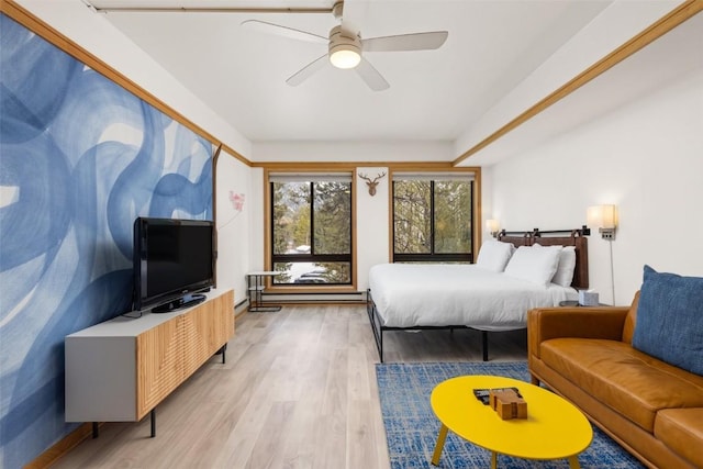 bedroom with ceiling fan and light hardwood / wood-style flooring