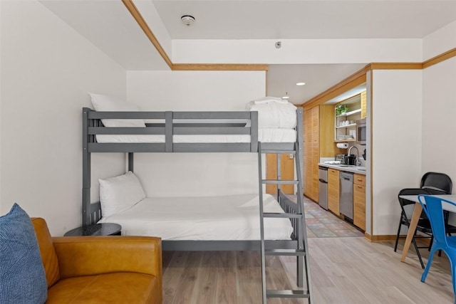 bedroom featuring sink and light hardwood / wood-style flooring