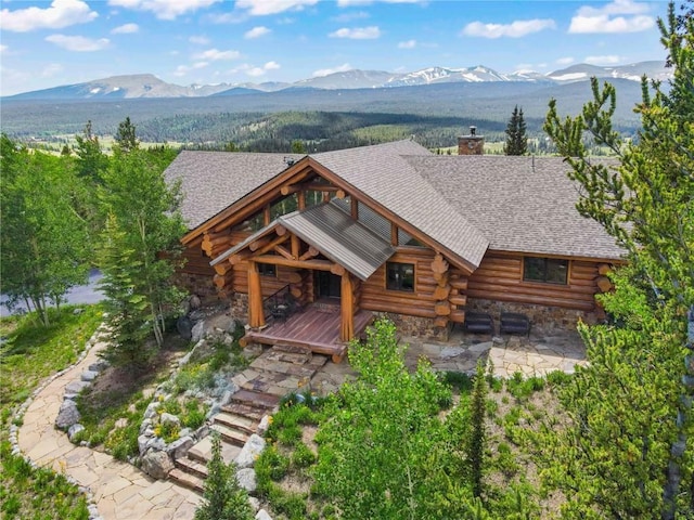 exterior space with a deck with mountain view