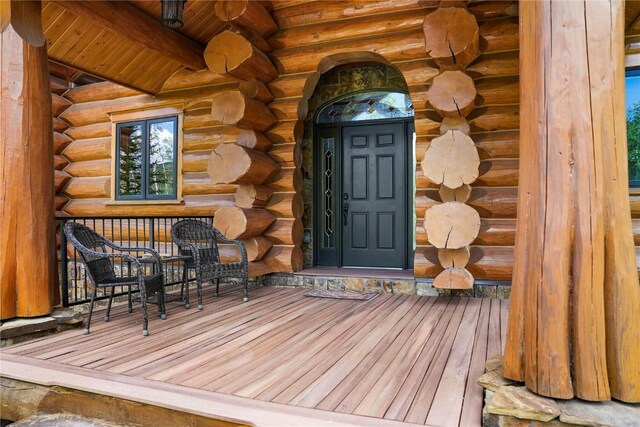 entrance to property featuring a porch