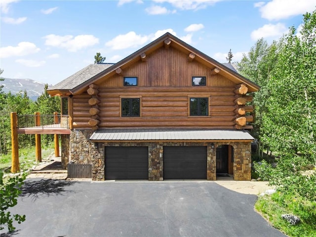 view of front facade with a mountain view, a balcony, and a garage