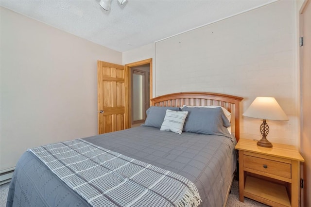 bedroom with a textured ceiling and carpet