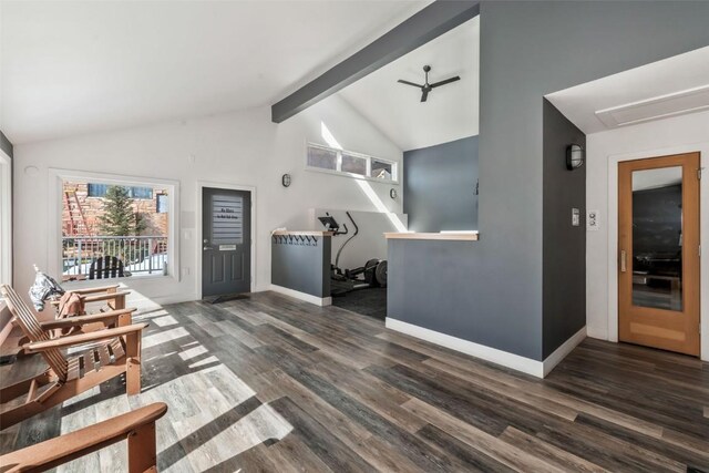 living room featuring lofted ceiling with beams, wood finished floors, and baseboards