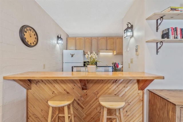 bar featuring freestanding refrigerator