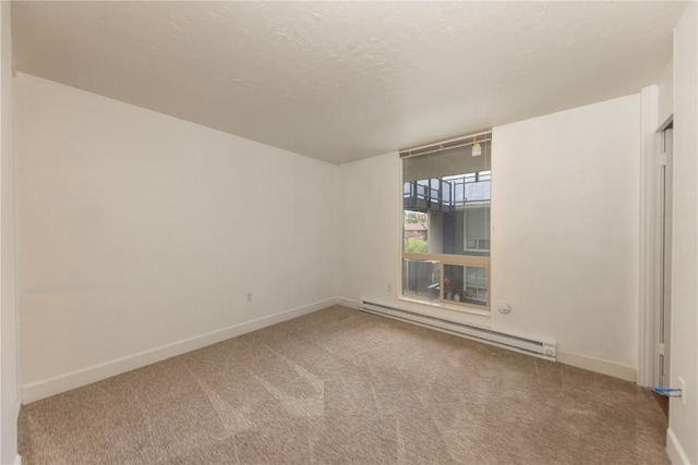 empty room featuring carpet floors and a baseboard radiator