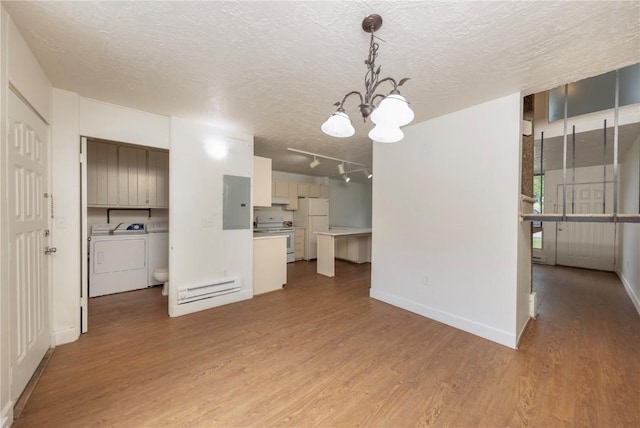 interior space with washing machine and dryer, white cabinetry, hanging light fixtures, and white appliances