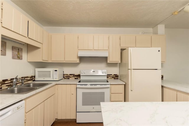 kitchen featuring cream cabinets, white appliances, a textured ceiling, and sink