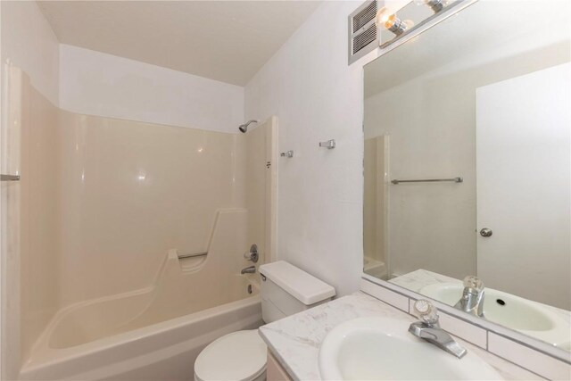 full bathroom featuring toilet, vanity, and washtub / shower combination