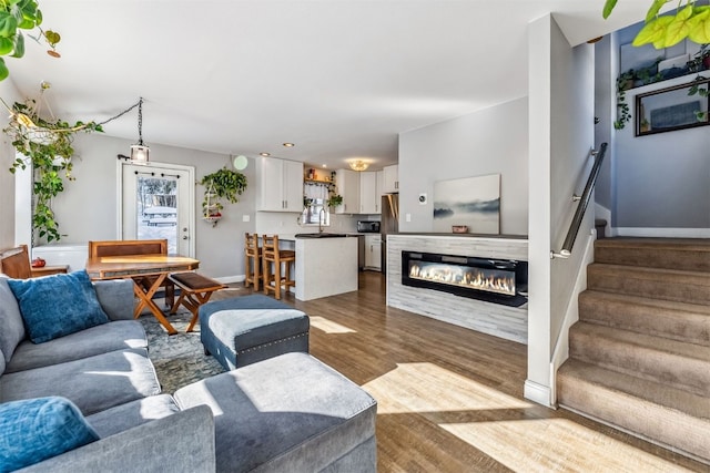 living room featuring a wealth of natural light and wood-type flooring