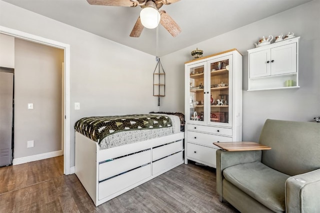 bedroom with ceiling fan and dark hardwood / wood-style floors