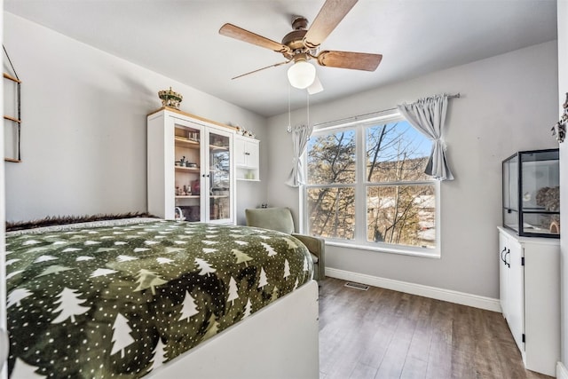 bedroom featuring ceiling fan and dark wood-type flooring