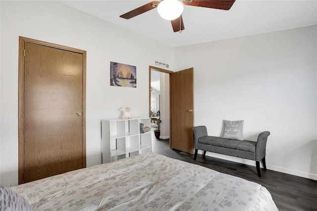 bedroom with ceiling fan, a closet, and dark hardwood / wood-style floors