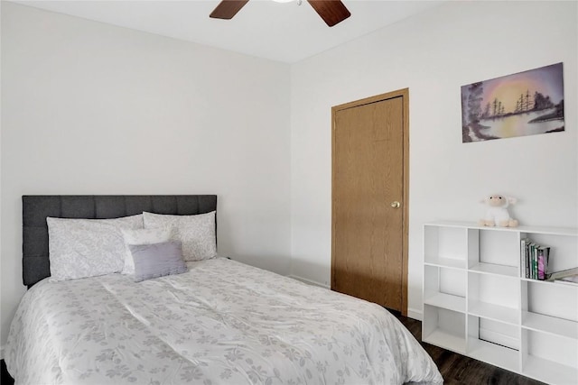 bedroom featuring ceiling fan and dark wood-type flooring