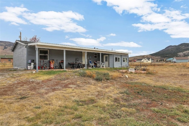 back of house with a mountain view