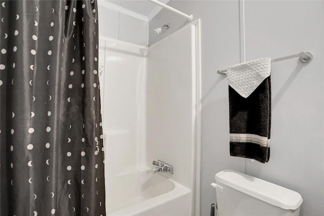 bathroom with shower / bath combination with curtain, a textured ceiling, and toilet