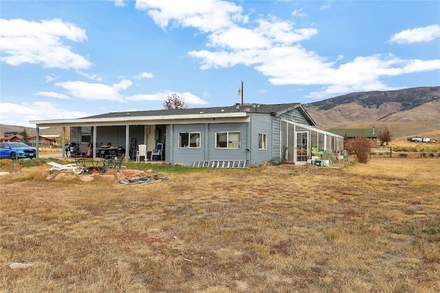 rear view of house with a mountain view