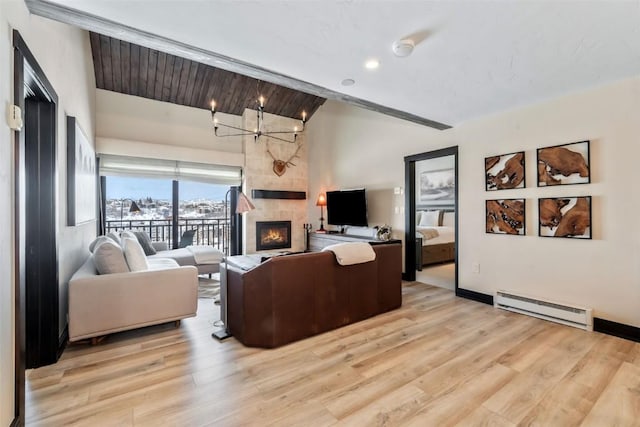 living room with baseboards, a tiled fireplace, lofted ceiling, light wood-style flooring, and a baseboard heating unit