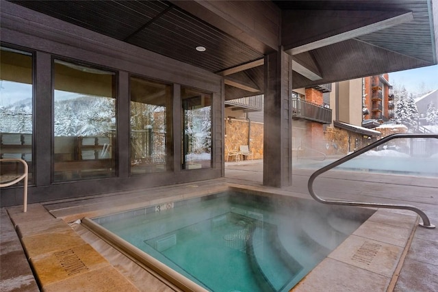 view of swimming pool featuring an indoor in ground hot tub and a patio