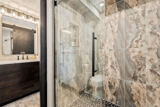 bathroom with a stall shower, vanity, and toilet