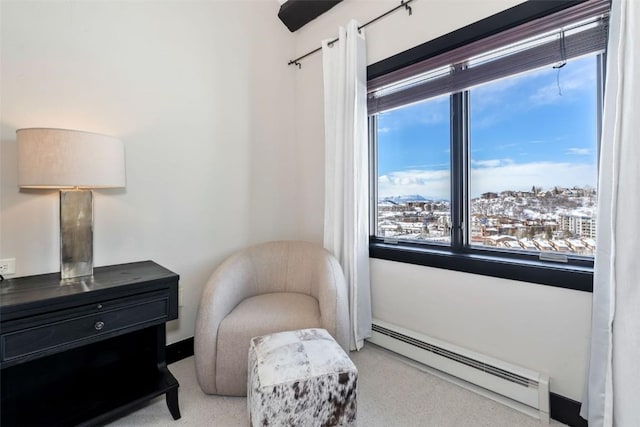 sitting room with a baseboard heating unit