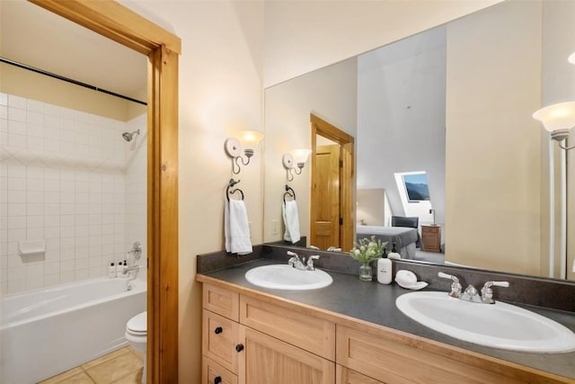 full bathroom with vanity, tiled shower / bath, tile patterned floors, and toilet