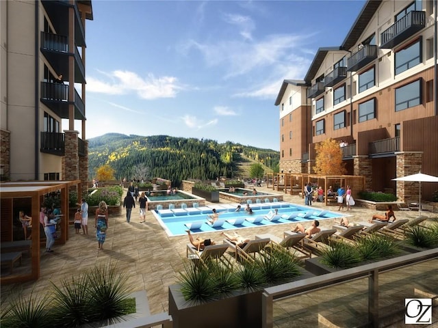 view of swimming pool featuring a mountain view