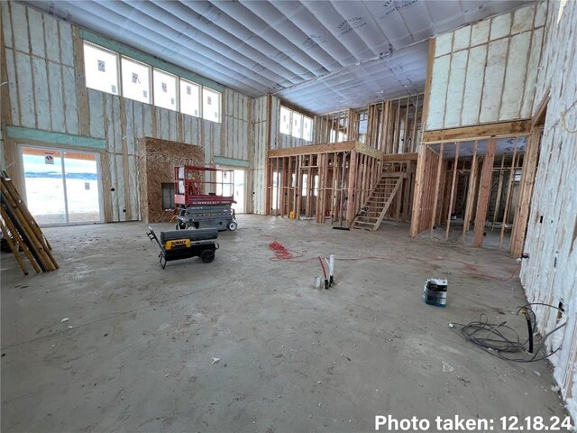 miscellaneous room with a towering ceiling