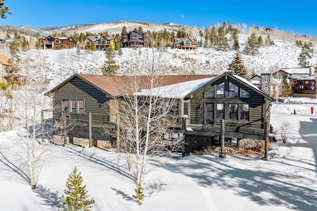 snow covered property featuring a mountain view