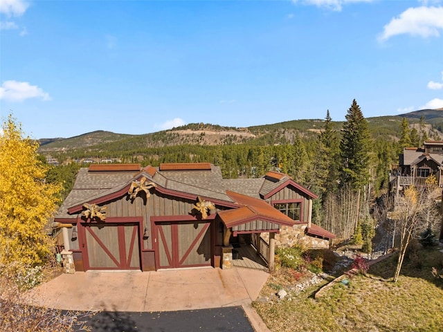 view of front of property with a mountain view and an outbuilding