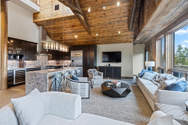 living room with beverage cooler, sink, high vaulted ceiling, wooden ceiling, and beamed ceiling