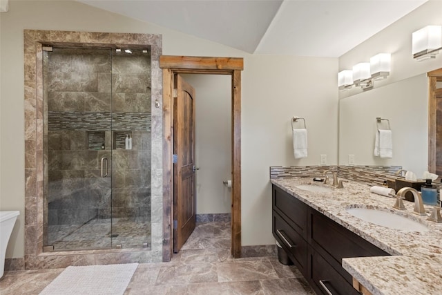 bathroom with vanity, lofted ceiling, and walk in shower