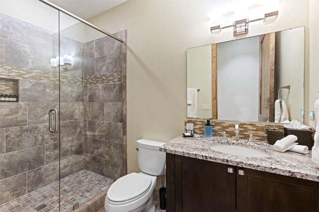 bathroom with vanity, toilet, and an enclosed shower