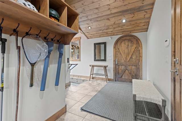 mudroom featuring lofted ceiling, wood ceiling, and light tile patterned floors