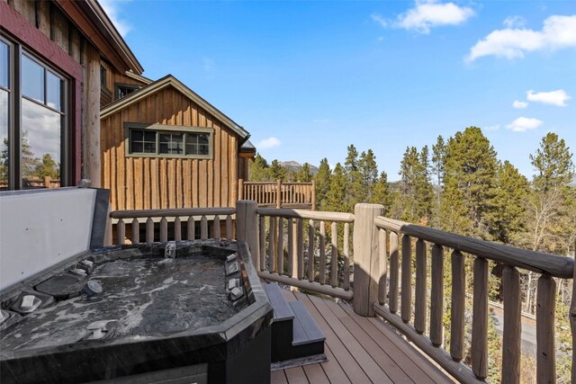 wooden deck with a hot tub