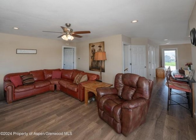 living room featuring dark hardwood / wood-style floors and ceiling fan