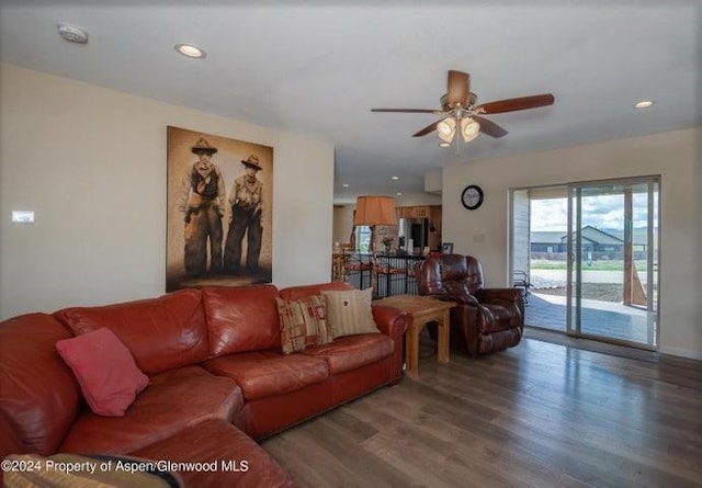 living room with ceiling fan and wood-type flooring