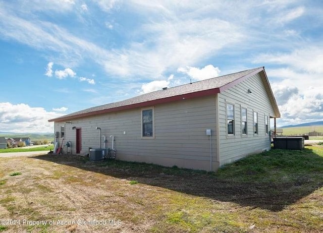 view of side of home with a yard