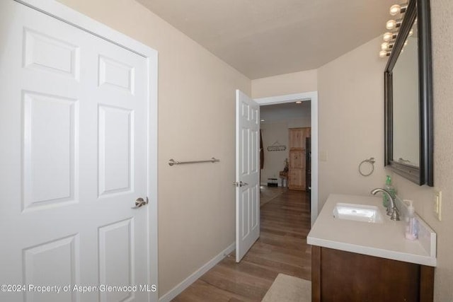 bathroom featuring vanity and wood-type flooring