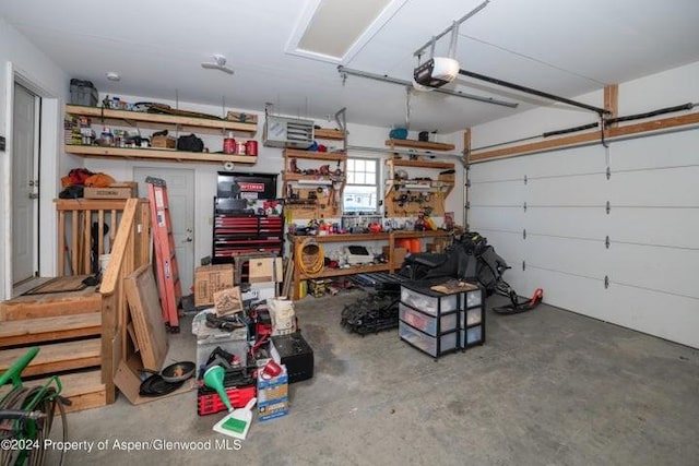 garage with a workshop area and a garage door opener