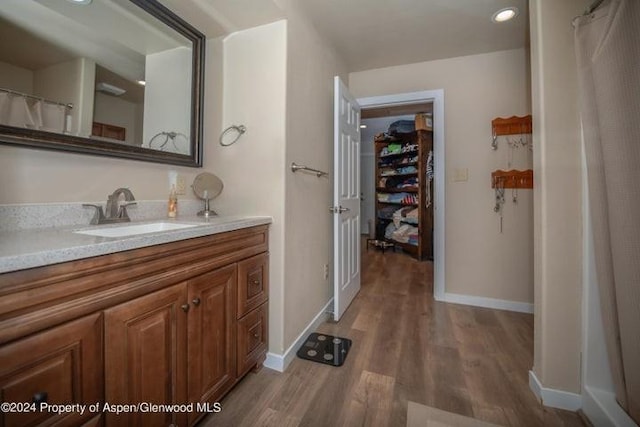 bathroom with hardwood / wood-style floors and vanity